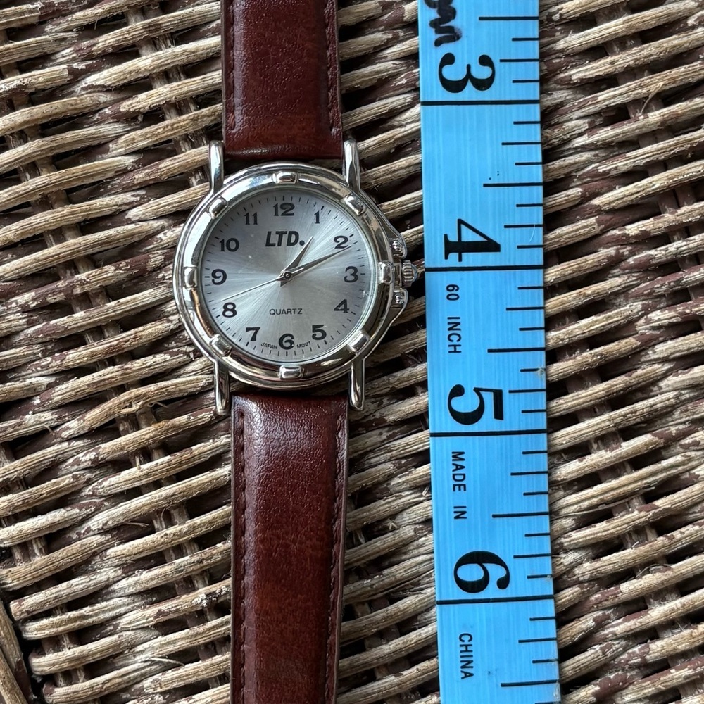 LTD WOMENS WATCH silver w/brown band. Runs great very good con w/new battery 35m